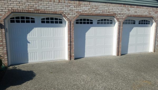 Three white garage doors